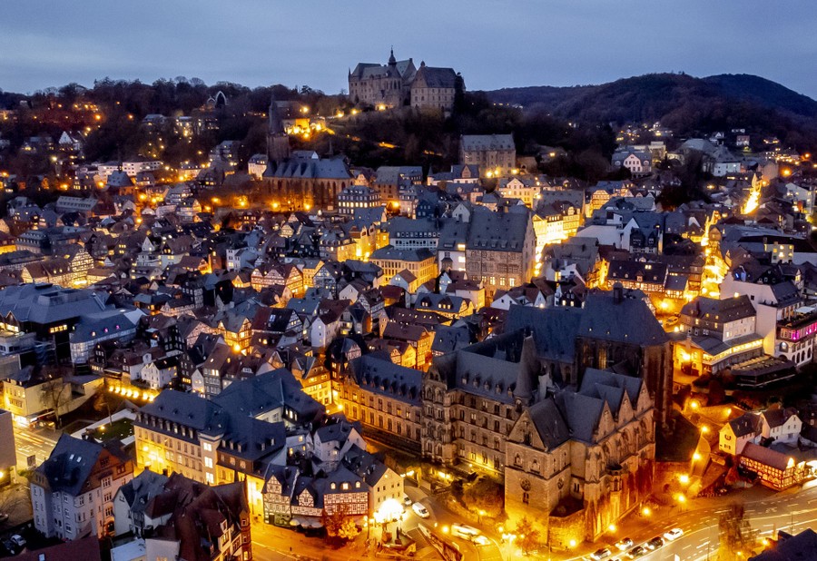 A late evening view of the old section of a German city, with the streets brightly lit