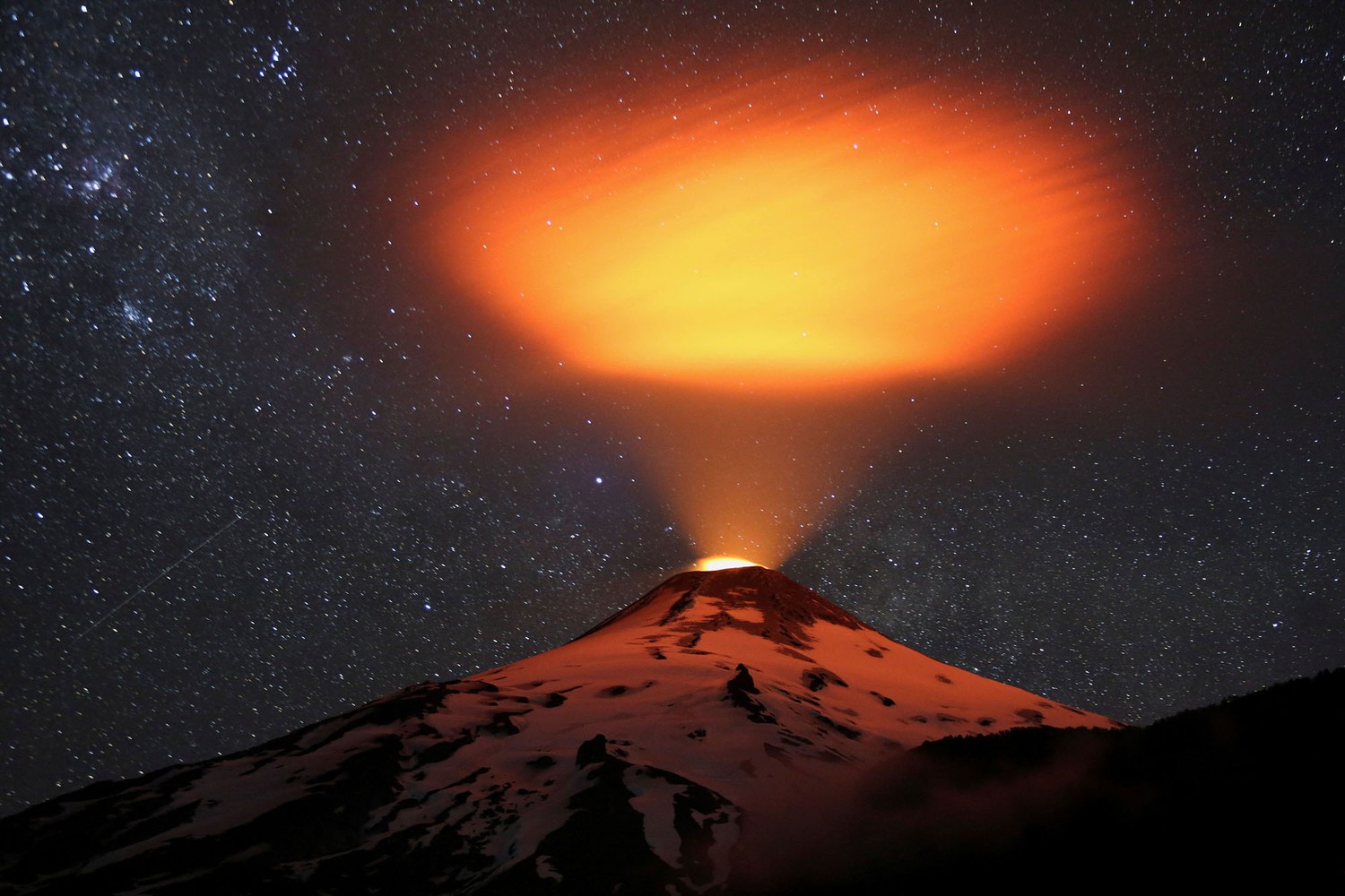 The Villarrica volcano lights up the sky at night, seen from Pucon town, Chile, on December 14, 2023. # Cristobal Saavedra Escobar / Reuters