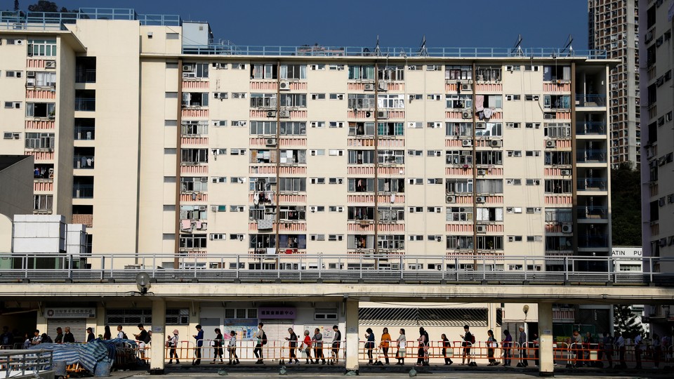 Voters line up in Hong Kong to cast their ballots in district-council elections.