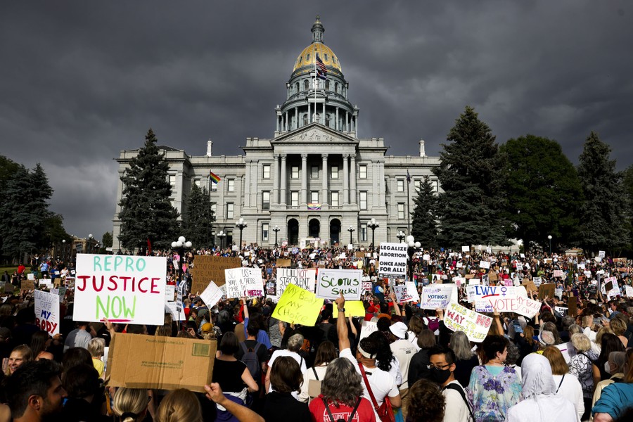 A large crowd of protesters in front of a state capitol building