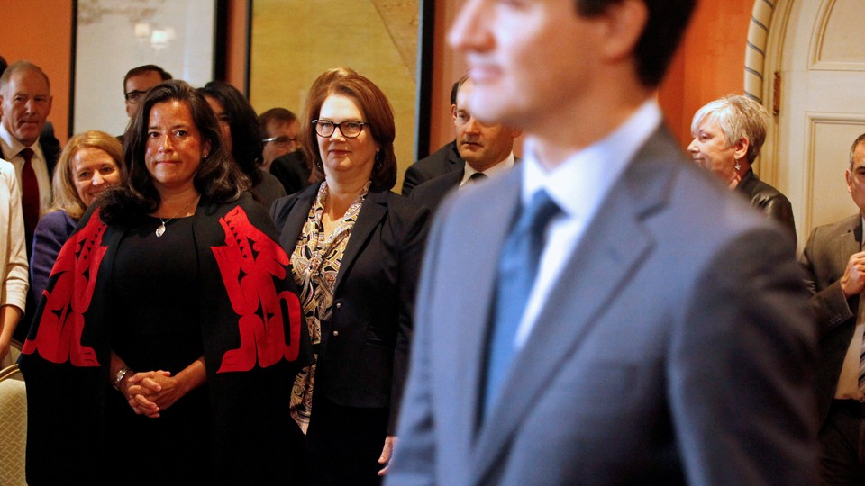 Jody Wilson-Raybould and Jane Philpott watch Justin Trudeau announce the shuffling of his cabinet ministers on January 14.