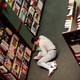 A man reads a book on the ground in a Barnes and Noble