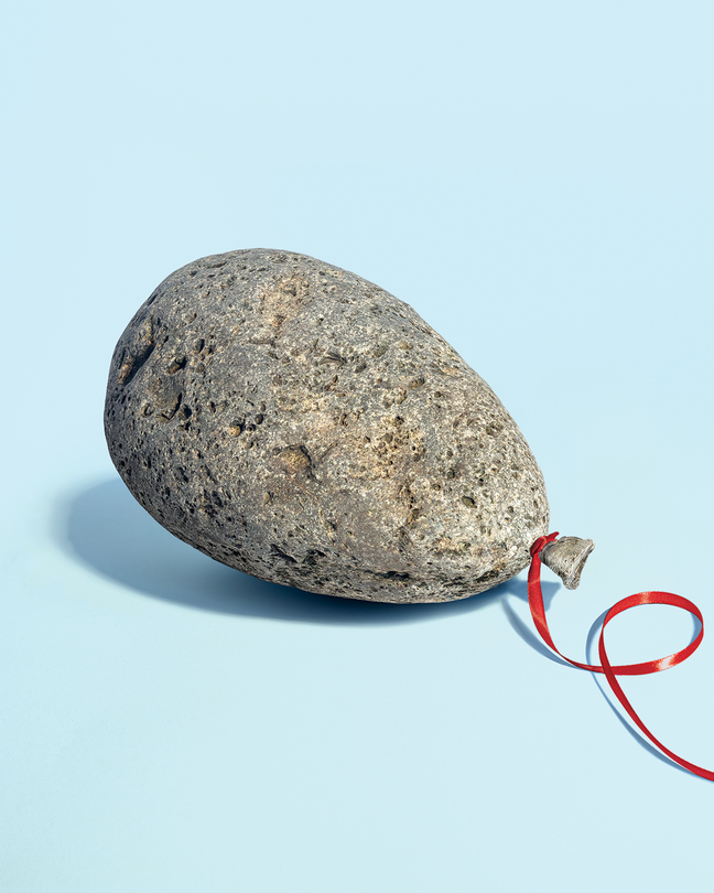 A photo realistic illustration of a balloon shaped rock with a red ribbon attached.