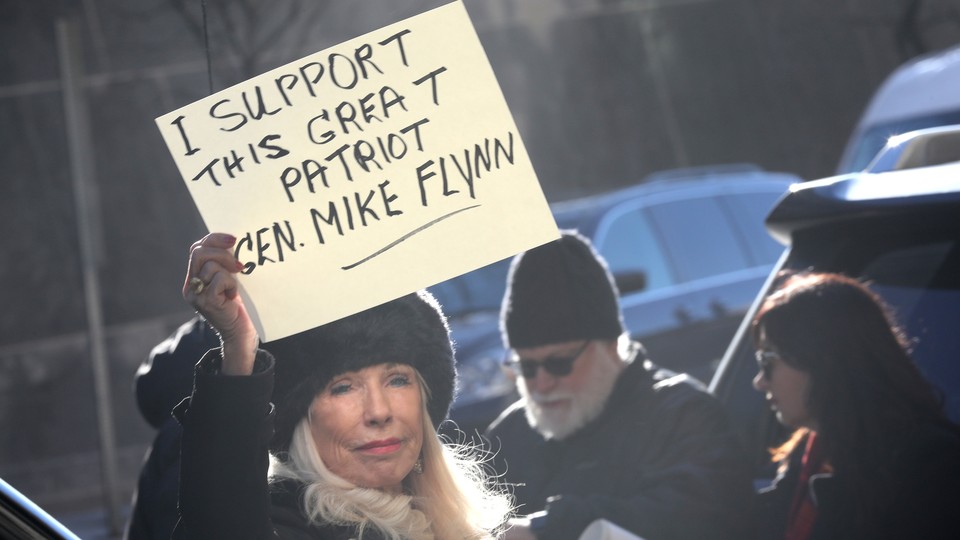 A demonstrator holds a sign in support of Michael Flynn before his sentencing hearing.