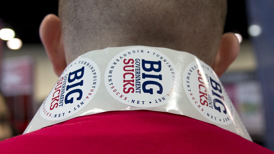 The back of someone wearing stickers that say "Big Government Sucks" around their neck