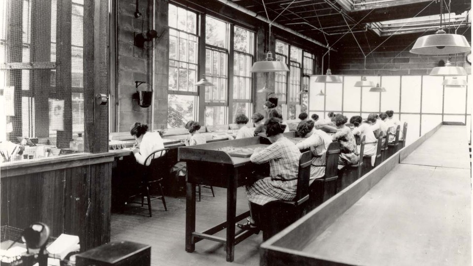 Women sitting at desks with trays