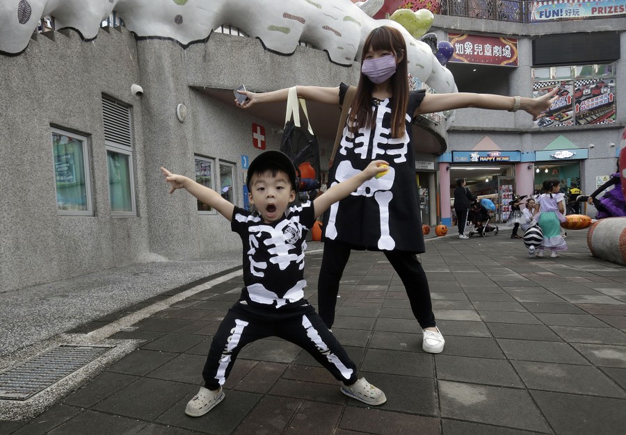 A mother and a son in skeleton costumes