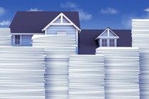 An illustration that shows housing surrounded by stacks of paper