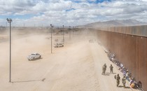 Photo of asylum seekers waiting along a border fence to be processed, March 2024, El Paso, Texas