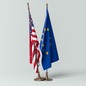 The U.S. flag standing next to the EU flag; the former's base rests atop the latter's.