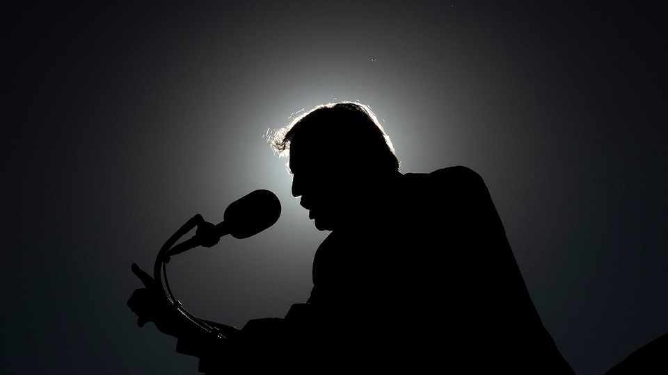 Silhouette of Donald Trump speaking into a microphone