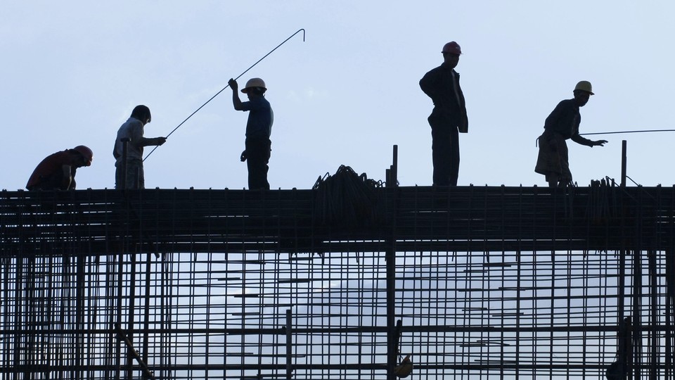 Silhouetted construction workers