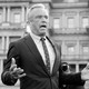 Black-and-white photograph of Robert F. Kennedy Jr. with his hands spread
