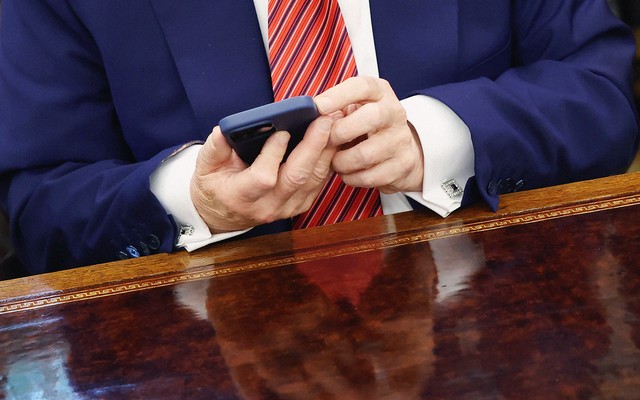 Donald Trump's hands holding a phone