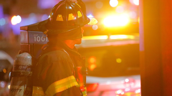 A firefighter in front of a fire engine