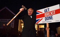 Boris Johnson with a sign reading "Get Brexit Done."