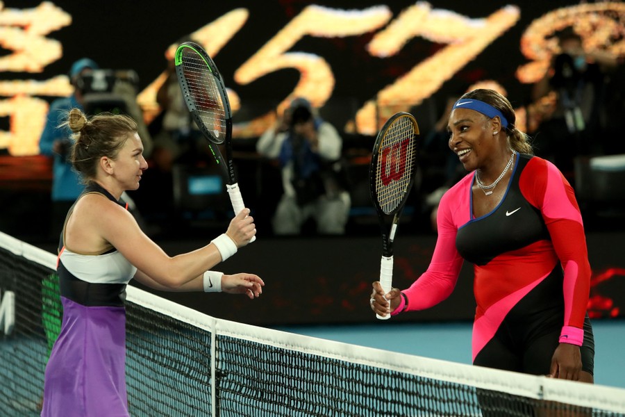 Serena Williams and Simona Halep touch rackets over the net.