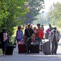 Asylum seekers walk down Roxham Road to cross into Quebec at the U.S.-Canada border in 2017.