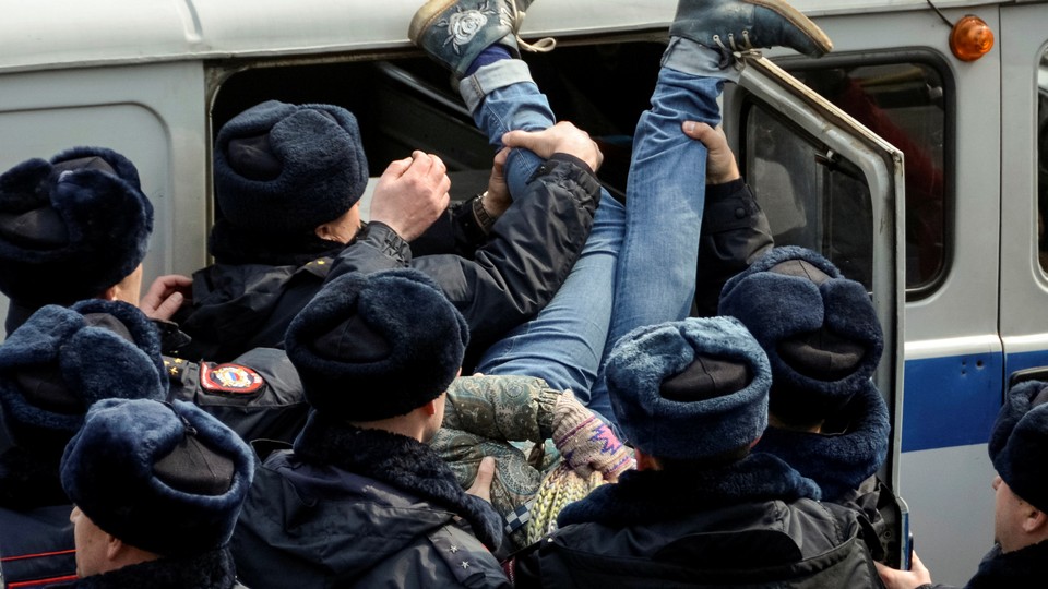 Police officers detain an opposition supporter during a rally in Vladivostok, Russia.