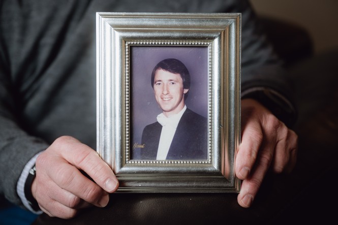 Jay Young holding a photograph of his father
