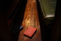 A bible on a pew.