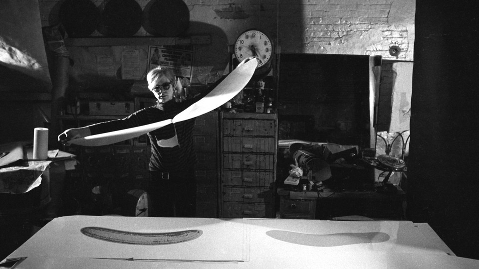 Andy Warhol working in his studio