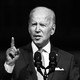 A black-and-white photo of Joe Biden delivering an address