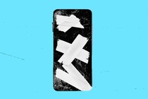A cracked iPhone screen with tape on it
