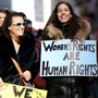 Two women hold placards in a women's rights march in New York City.
