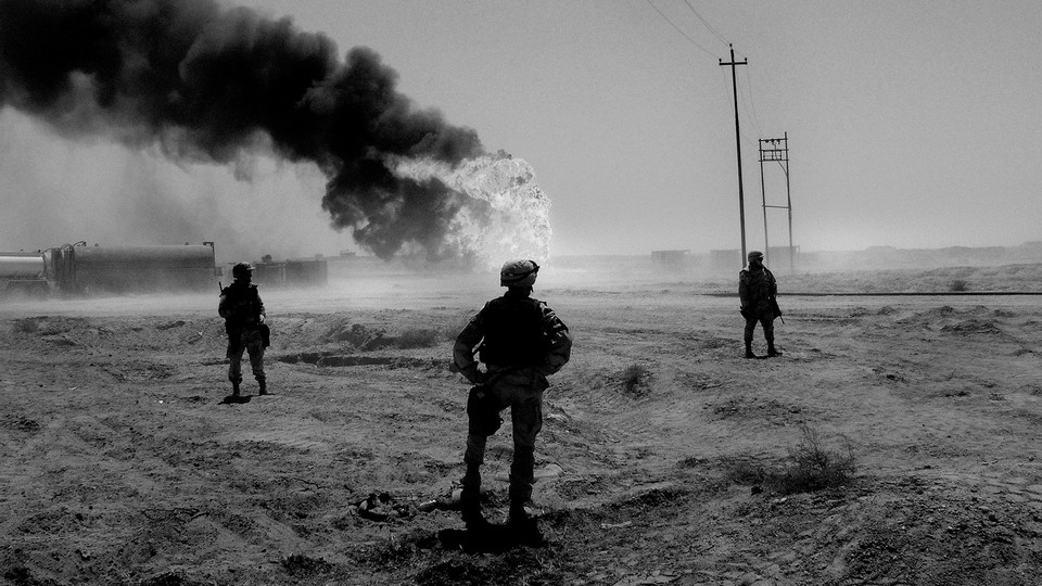 An image of U.S. soldiers standing guard over an Iraqi oilfield, 2003