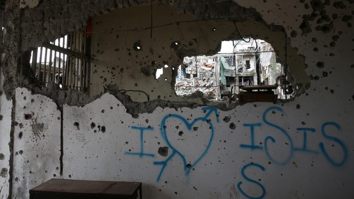 Graffiti that reads "I love ISIS" is seen in a damaged building in Marawi City, Philippines.