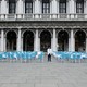 A waiter stands by empty tables outside a restaurant at St Mark's Square, which is usually full of tourists, after Italy's government adopted a decree with new emergency measures to contain the coronavirus