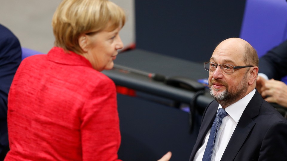 Chancellor Angela Merkel speaks with Martin Schulz.