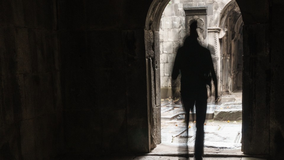 man walking out of a church door