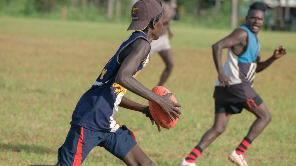 Aboriginal youths play football in Australia's Northern Territory.