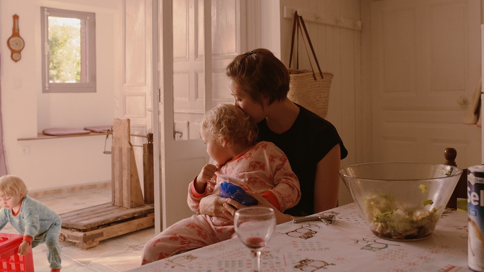 photo of a mother and her two children at home