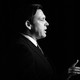 Black-and-white photo of Ron DeSantis in profile, talking and gesticulating