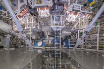 A photograph of the National Ignition Facility's target chamber, with ladders and pipes and tubes and other equipment