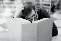 A man reads a very large book