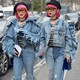 Two women with pink hair dressed in matching denim outfits