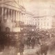 An older photograph showing a crowd (looking blurry due to movement) in front of the U.S. Capitol building during an inauguration ceremony.