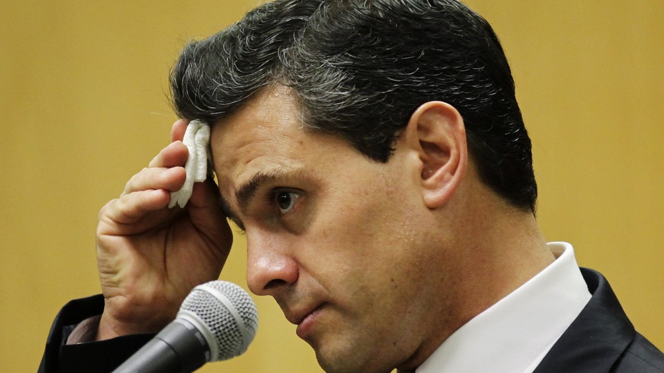 Pena Nieto, presidential candidate for the PRI, listens during a news conference in Mexico City in 2012.