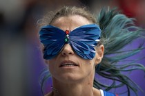 A runner wears a butterfly-shaped blindfold while competing at the Paralympic Games.