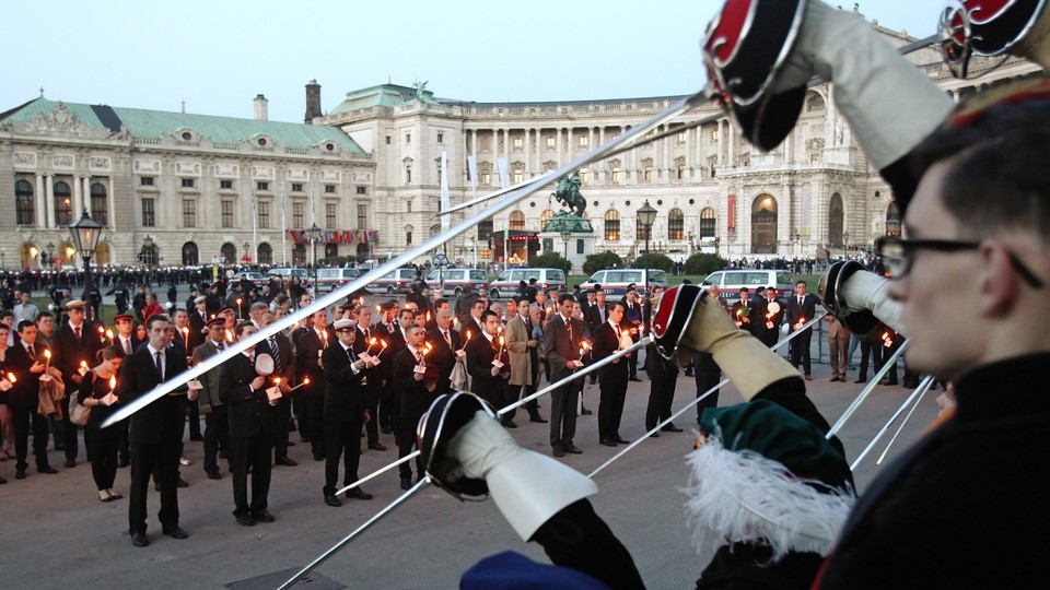 Members of traditional Austrian fraternities hold torches and raise their swords during a commemoration ceremony for the victims of World War II in Vienna in 2012.