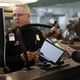 A traveler scans their fingerprints at an airport checkpoint.