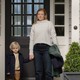 A still photo of Sarah Snook as Marissa, holding her son's hand in front of the door of a house, on "All Her Fault."