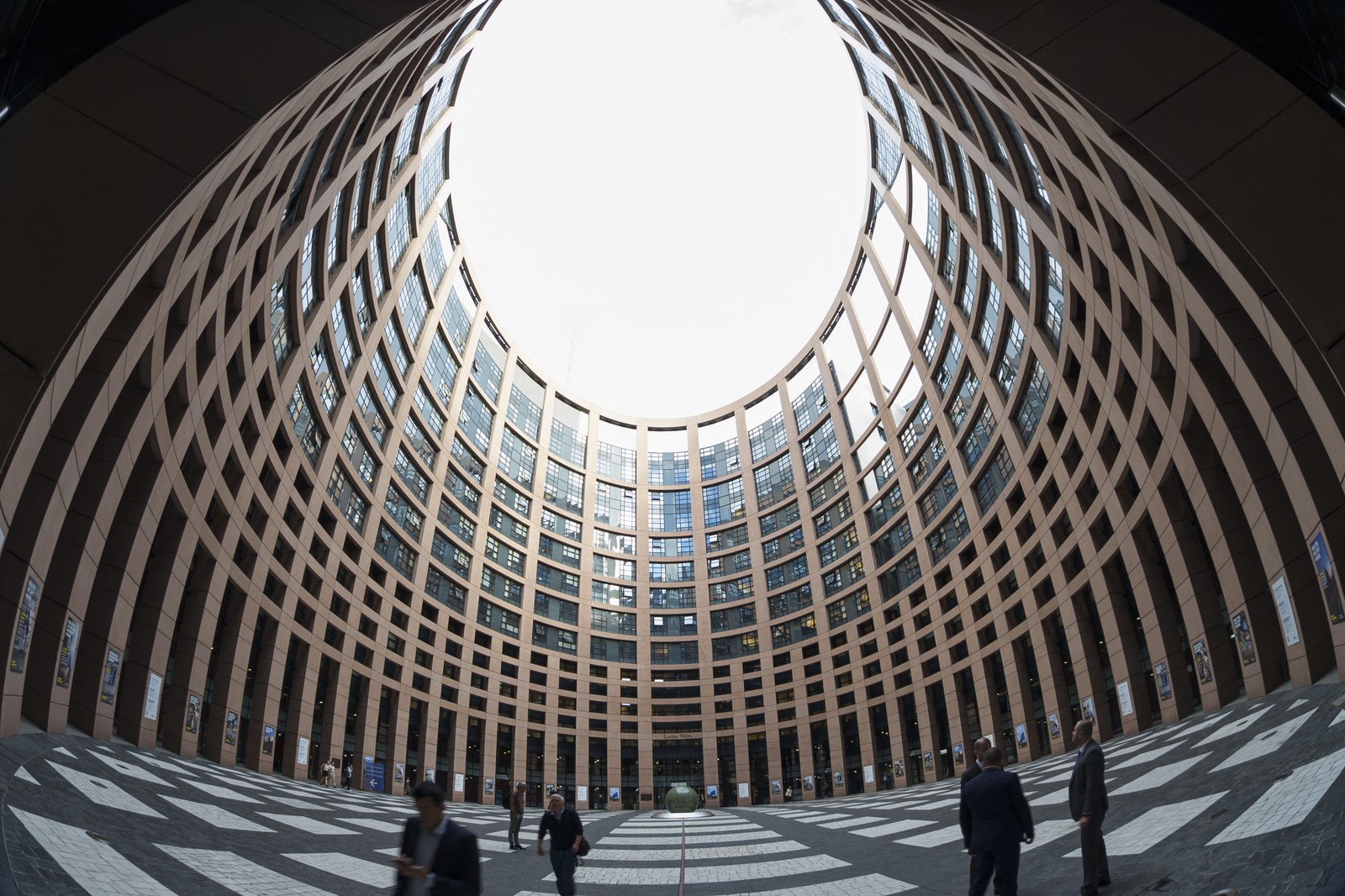 A fisheye-lens view of the interior of a circular courtyard inside a building.