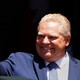 Ontario Premier Doug Ford waves during his unofficial swearing-in ceremony in Toronto in 2018.