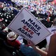 An attendee holds a "Make America Safe Again" sign on the second day of the 2024 Republican National Convention.