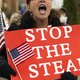 A woman yells while holding a "STOP THE STEAL" sign